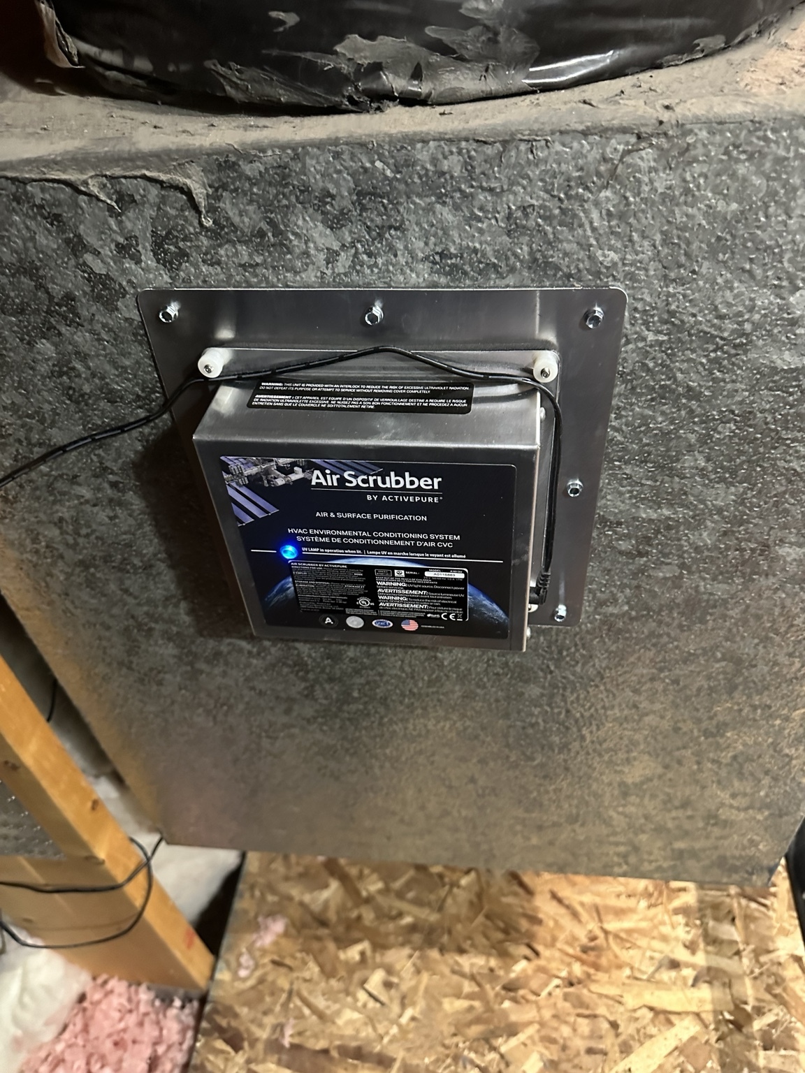 Heating, Furnace & AC Repair in Las Vegas, NV Air Scrubber mounted on metal HVAC ductwork with its indicator light illuminated.
