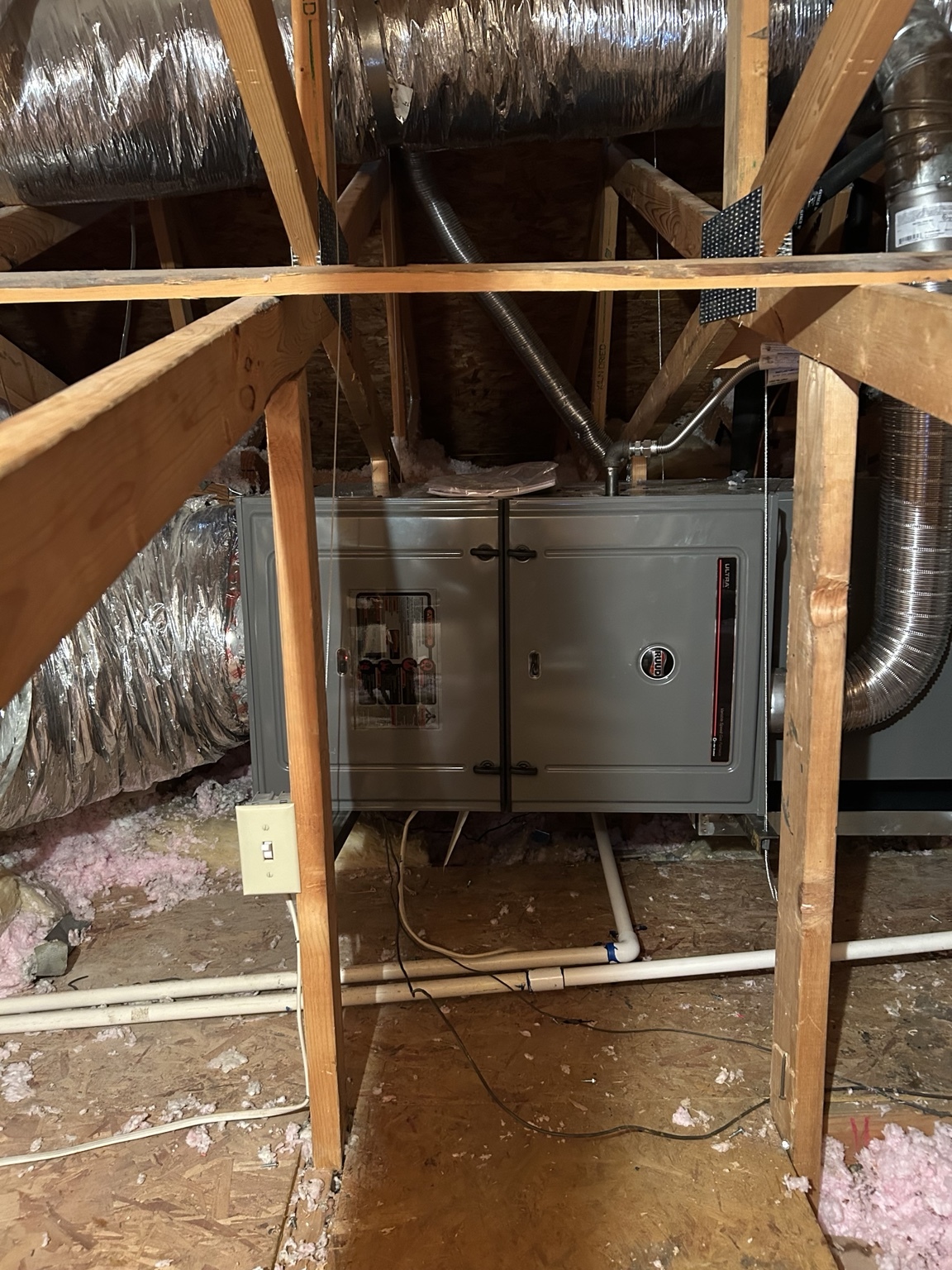 Heating, Furnace & AC Repair in Las Vegas, NV RUUD furnace installed horizontally in an attic with connected ductwork.
