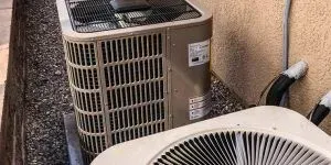 Two outdoor AC units showing professional repair setup