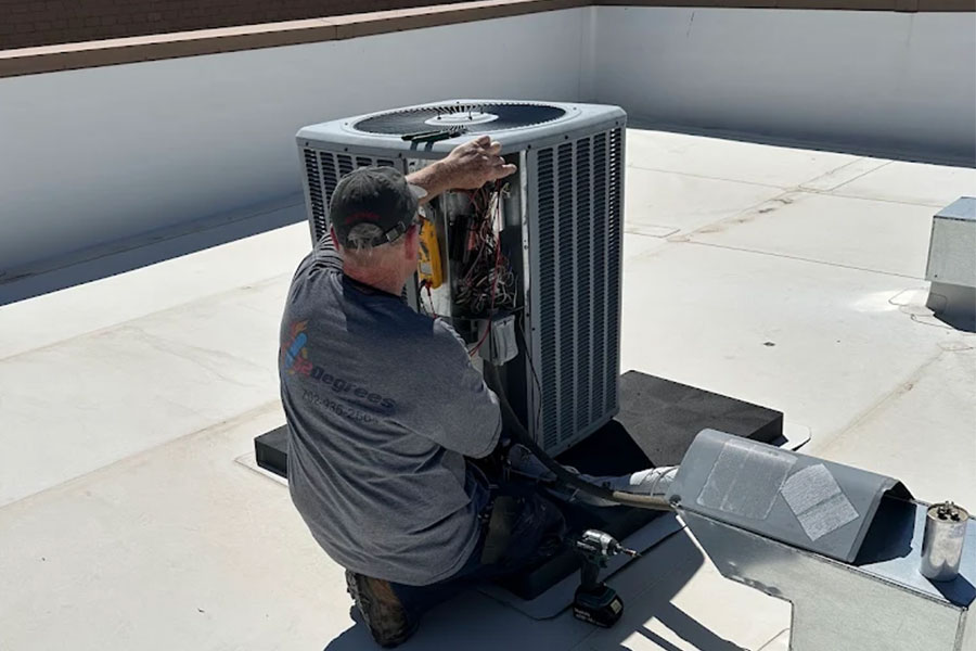 32 Degrees technician repairing rooftop HVAC unit