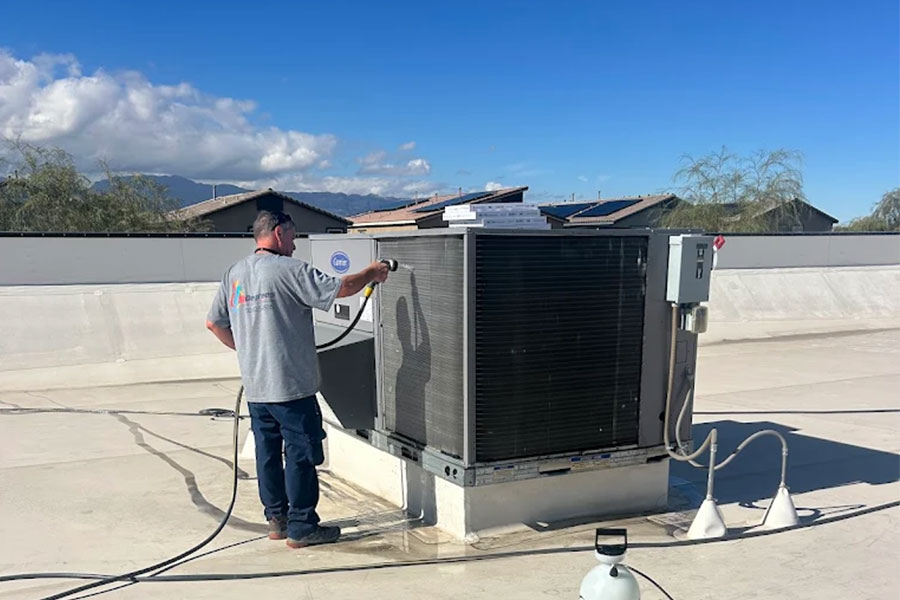 32 Degrees technician cleaning rooftop HVAC unit in Las Vegas