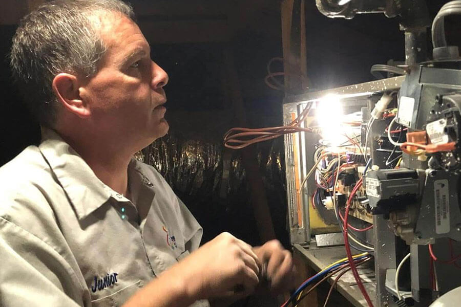 32 Degrees technician troubleshooting furnace during emergency HVAC repair