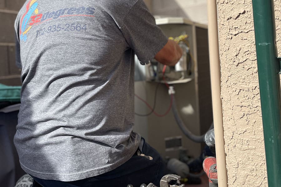 32 Degrees technician replacing AC capacitor in Las Vegas