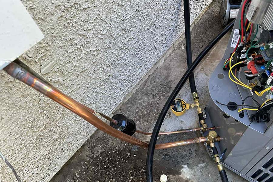 AC maintenance gauges connected to outdoor unit in Las Vegas