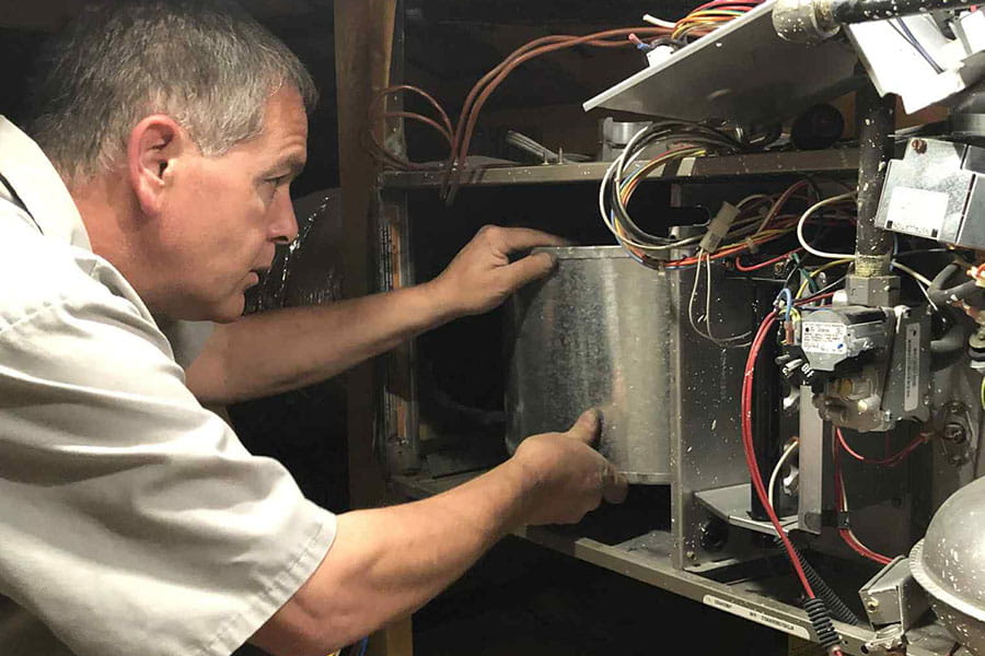 32 Degrees technician diagnosing furnace wiring during repair service in Las Vegas NV