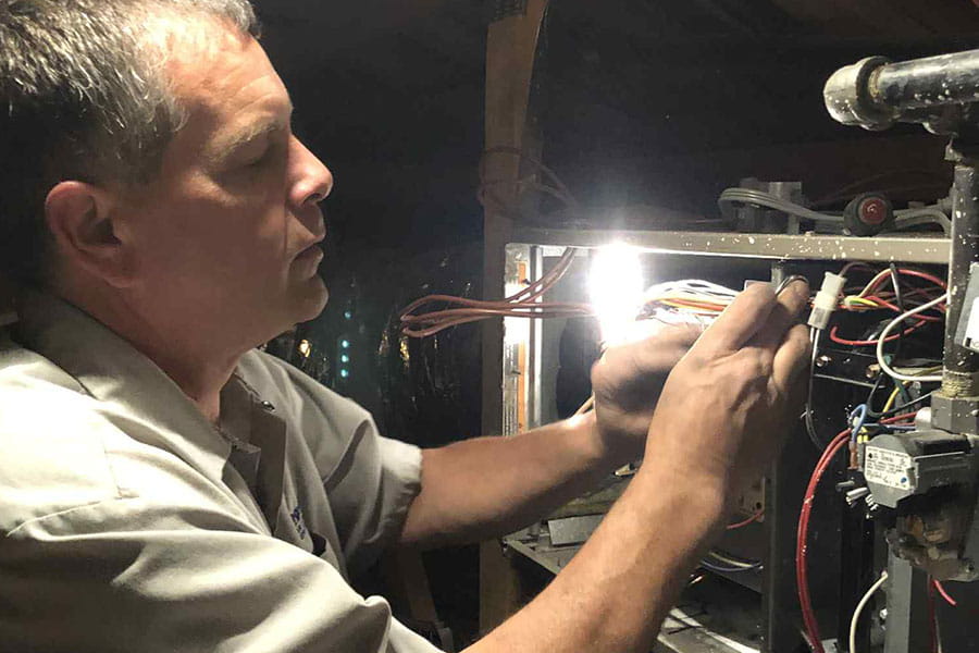 32 Degrees HVAC technician repairing furnace wiring in Las Vegas NV home