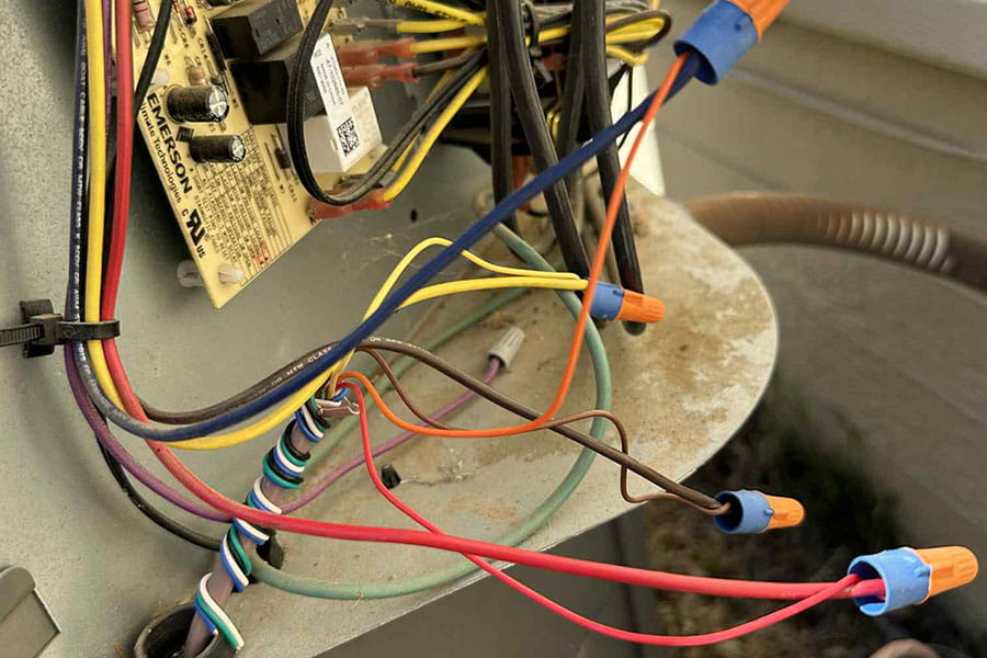 Heat pump wiring checked during maintenance service in Las Vegas home