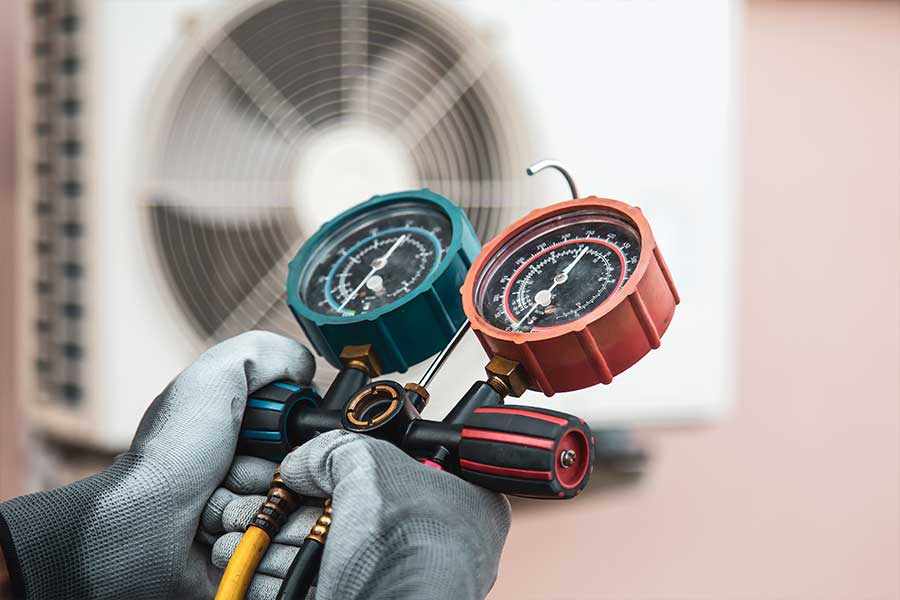 HVAC technician checking refrigerant pressure on a ductless mini split in Henderson, NV